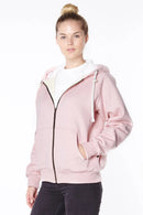 Woman wearing a light pink hoodie with a white collar on a white background
